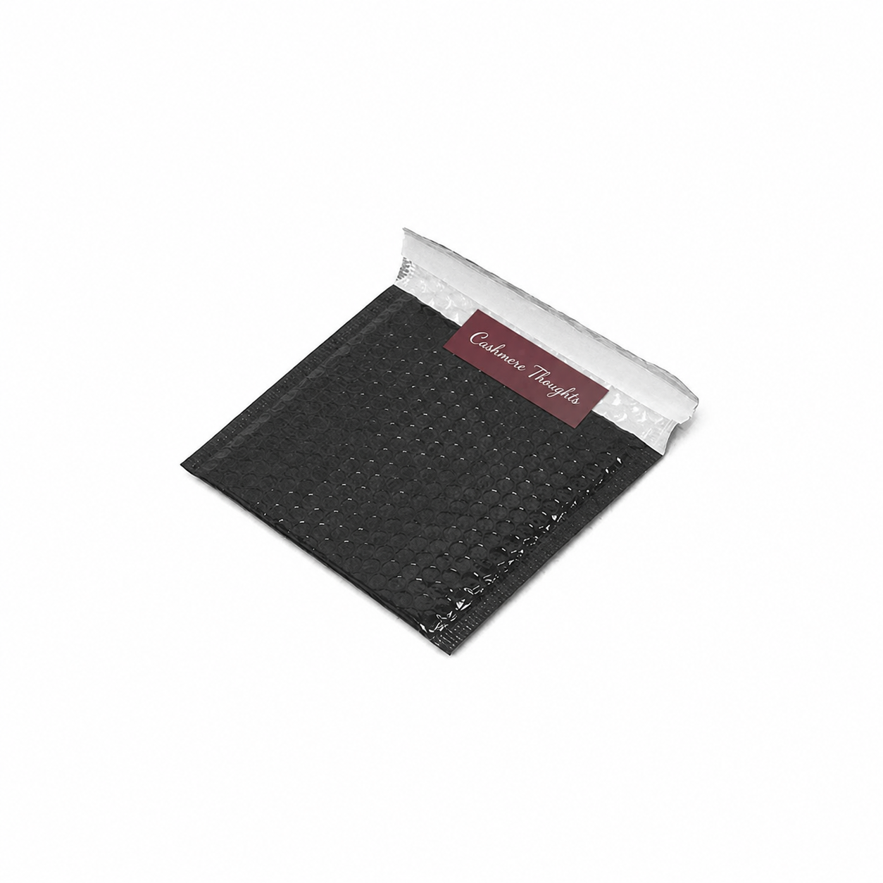 Kite black metallic CD bubble envelope with 50 by 25 millimetre Cashmere Thoughts seal sticker