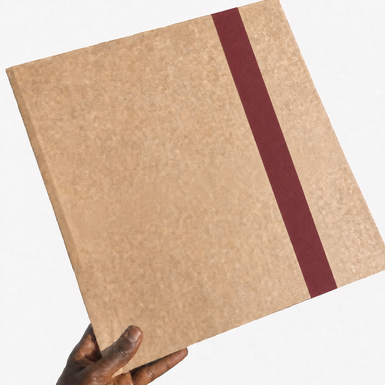 TPC LP Wrap held by a Black hand with burgundy tape sealing the opening fold
